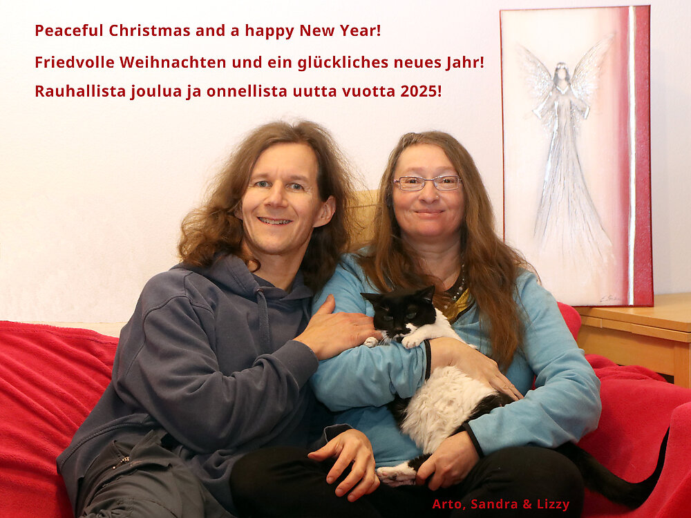 A portrait of us with our beloved cat Lizzy, December 2024.