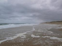 The waves left their bubbles like soap on the sand